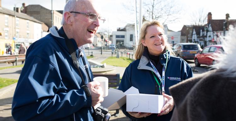 To Healthwatch volunteers speaking to someone at an outdoor event